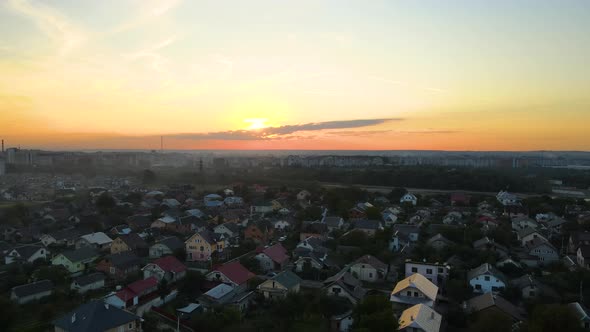 Aerial View of Residential Houses in Suburban Rural Area at Sunset alt