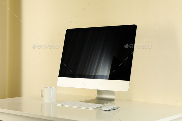 Minimalist workspace concept with desktop computer on beige background