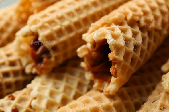 Tasty wafer rolls with condensed milk, close up