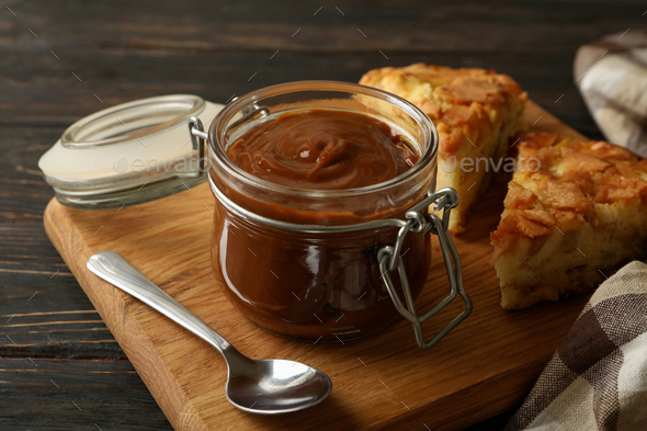 Board With Pie And Caramel Condensed Milk On Wooden Background Stock Photo By Atlascomposer