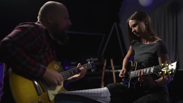 Friends Give Each Other a High Five After a Beautifully Played Riff alt