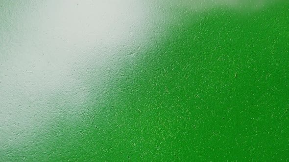 Painting Green Walls with White Paint Using Spray Can Closeup alt