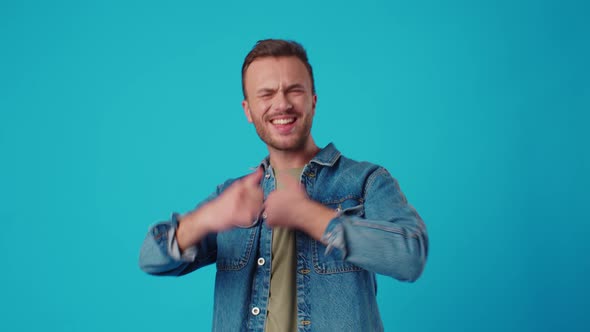 Young Man Celebrating Success on Blue Background