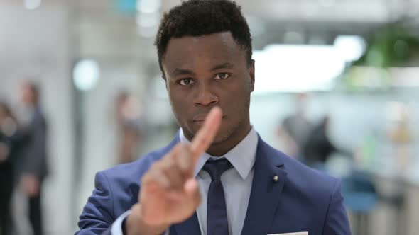 Portrait of African Businessman Showing No Sign By Finger Sign alt