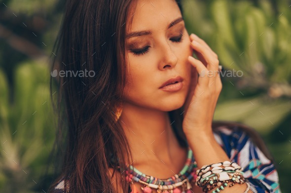 Close up beauty portrait of gorgeous Asian model in boho summer outfit