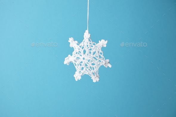 Knitted snowflake in air