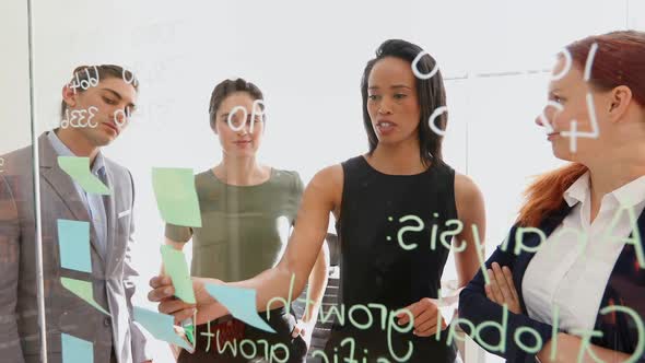 Group of executives discussing over information on the wall 4k alt