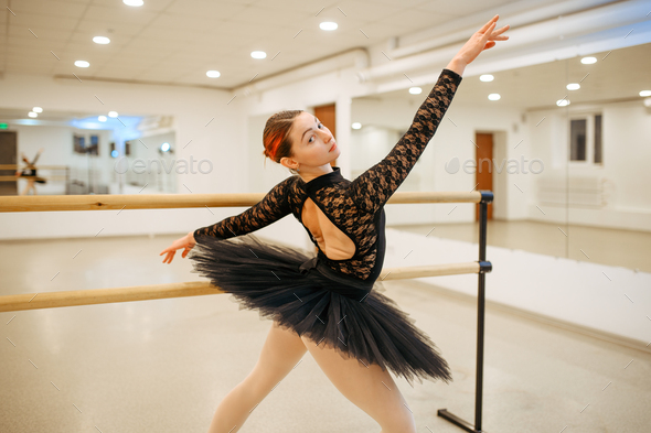 Choreographer poses at the barre, ballet school