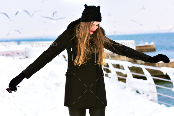 Fashion winter portrait of elegant blonde lady woman, enjoy cold snow time at the sea