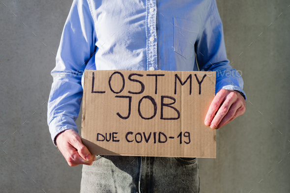 Man with cardboard sign LOST JOB
