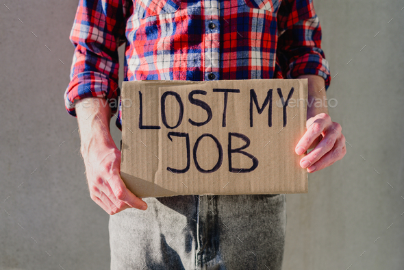Man with cardboard sign LOST JOB
