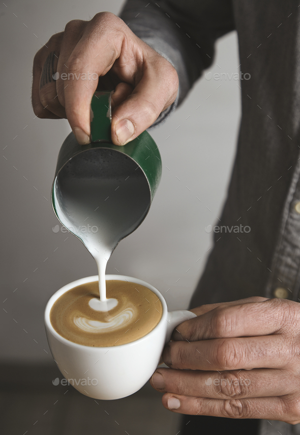 Barista pours ground coffee to aeropress Stock Photo by bublikhaus