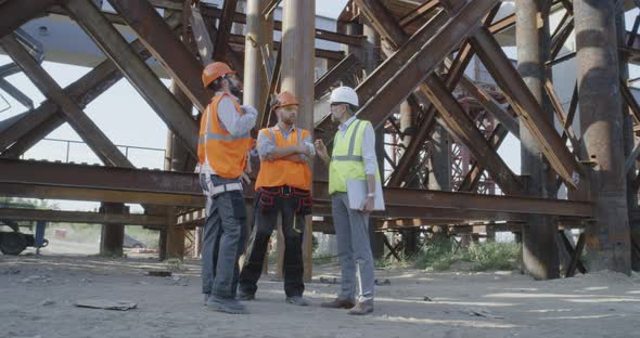 Builders Talking Near Metal Structure alt