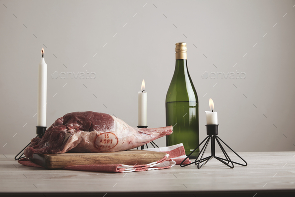 Candles lamb leg wine bottle isolated on table