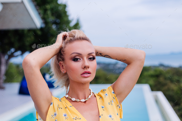 fashionable african american woman with glitter makeup posing in yellow  dress Stock Photo - Alamy
