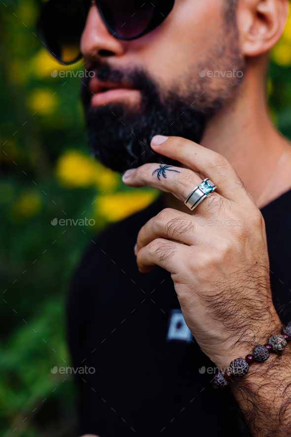 bearded man in sunglasses having palm tree tattoo on finger Stock Photo by  kroshkanastya