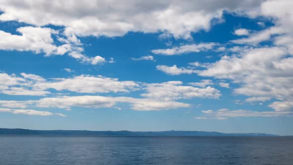 Blue Sea Landscape With Clouds Above 