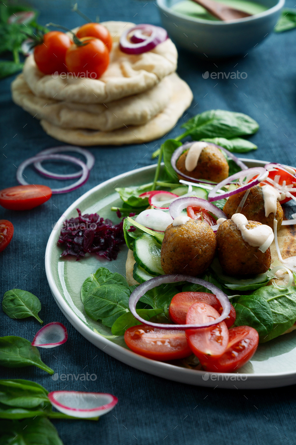 Home made vegan falafel served with various mezze and pita bread