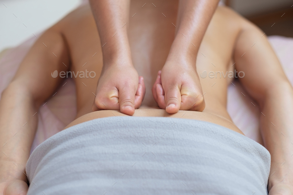 Caucasian woman getting a back massage in the spa salon Stock