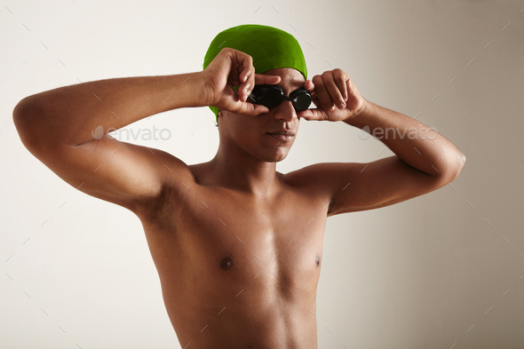 Closeup of a young black swimmer in cap and goggles