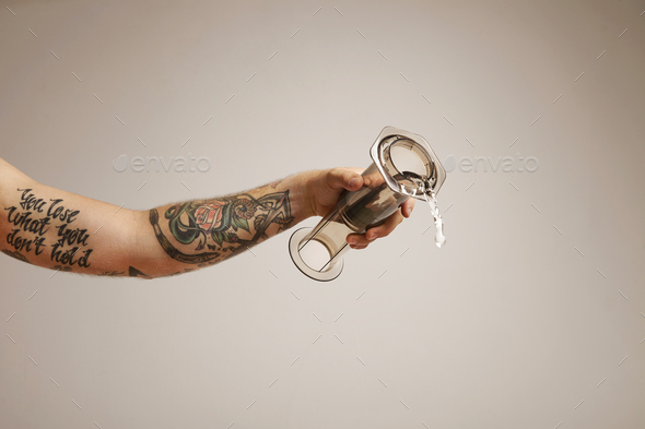 Barista pours ground coffee to aeropress Stock Photo by bublikhaus