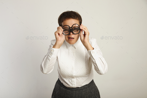 Teacher in white blouse with 3 pairs of glasses