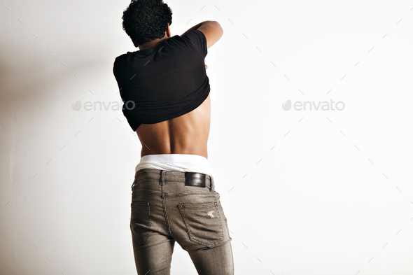 Hot latino young man taking off his t-shirt