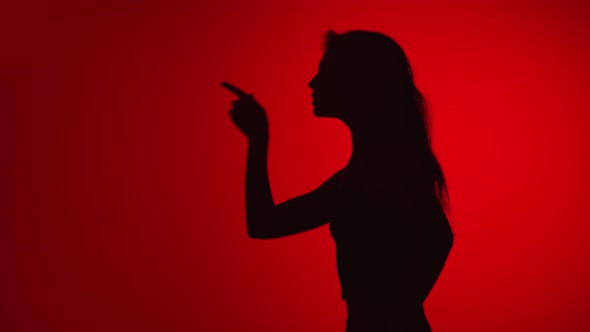 Silhouette of Woman Wagging Index Finger Scolding with Angry Expression alt
