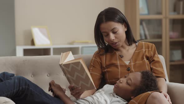 Mother Reading Book to Boy alt