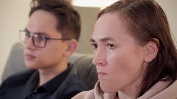 A Woman and Her Teenage Son are Watching TV alt