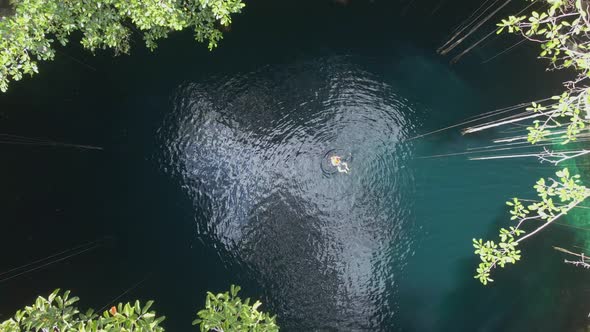 Female Tourist Swim in Open Cenote