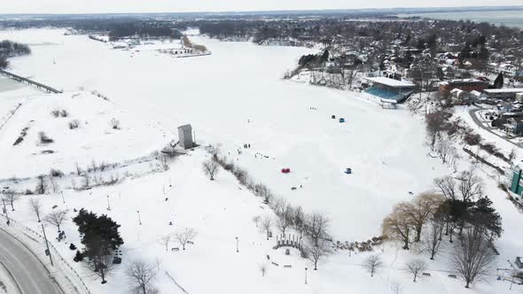 Many people ice skating in the nature on frozen lake. Winter sport in the nature alt