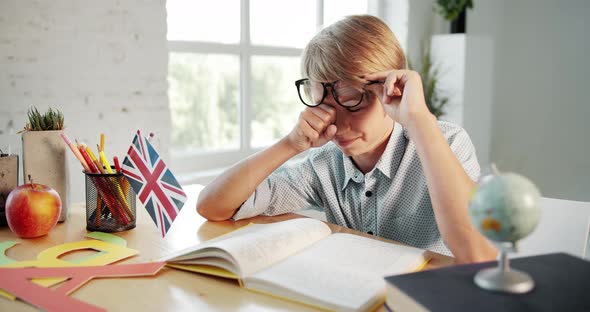 Tired Boy Reading English Book