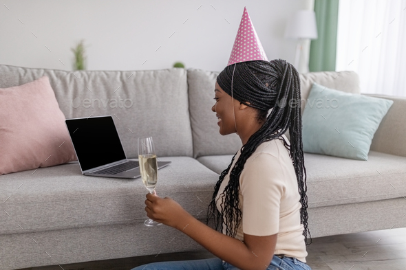 Young african american lady having online party from home