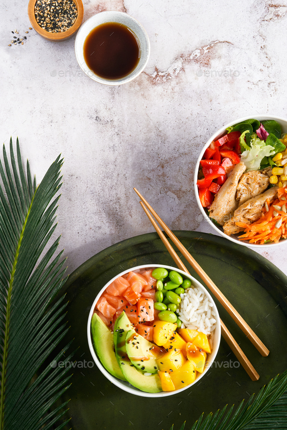 Hawaiian trendy poke bowls with salmon, heura soy protein or vegan chicken, variety vegetables.
