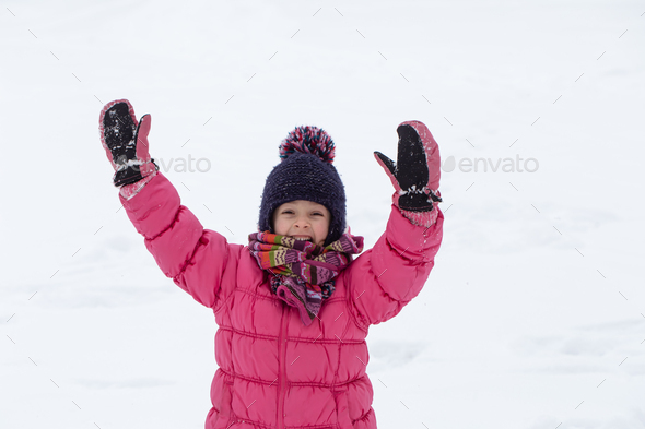 Happy Young Girl with Winter Snow Clothes Playing, Real Life Stock