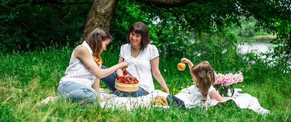 grandmother, daughter and granddaughter on a picnic