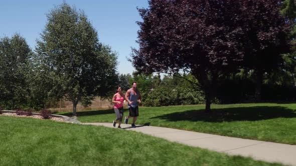 Athletic couple running at park