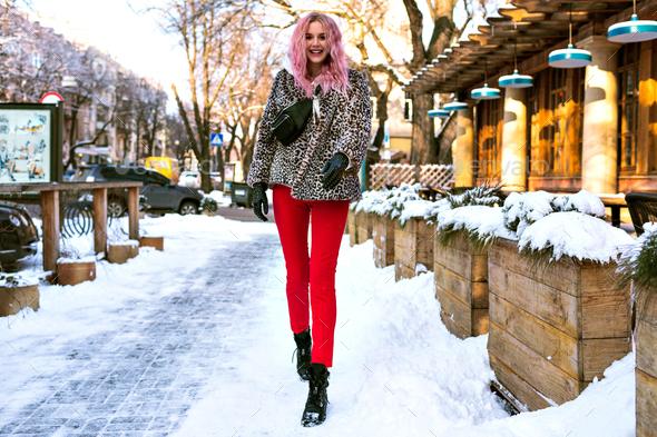 Winter outdoor fashion portrait of stylish young woman posing at snowy  European city, Stock Photo by Haritanita