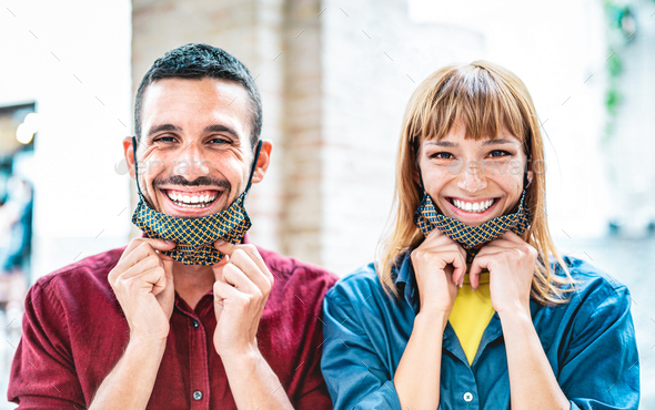 Happy couple in love smiling with open face mask - Stock Photo - Images