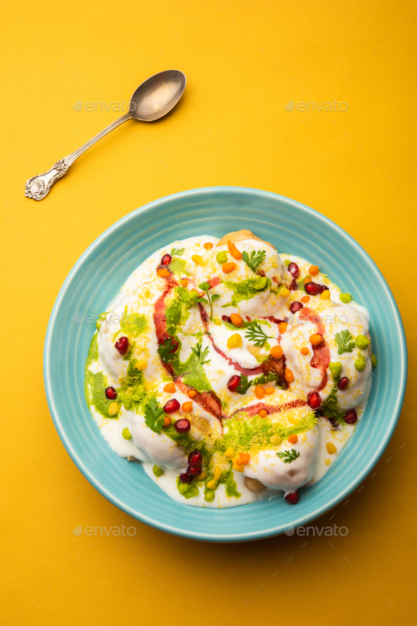 Dahi vada is Indian snack food. Garnished with coriander, boondi