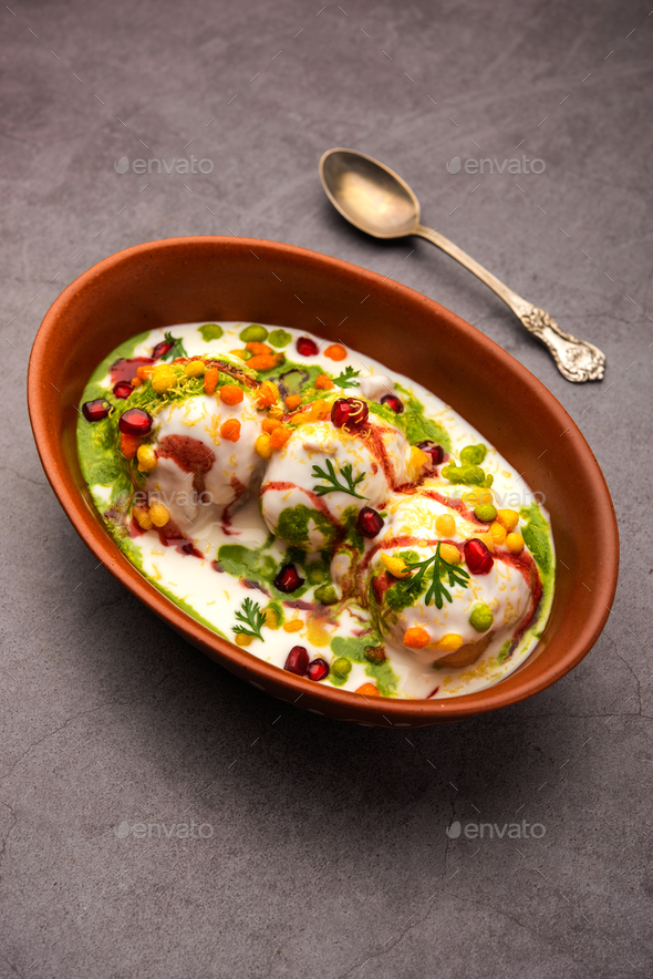 Dahi vada is Indian snack food. Garnished with coriander, boondi