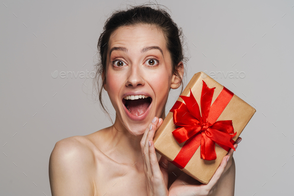 Excited Half Naked Woman Screaming While Showing Gift Box Stock Photo