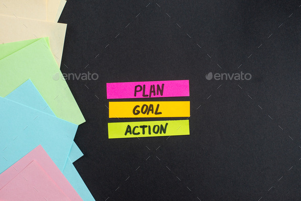 top view plan goal action notes with stickers on dark background motivation color job business