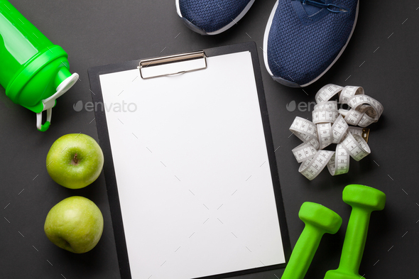 Fruits, dumbbells and blank sheet for your plan or goals