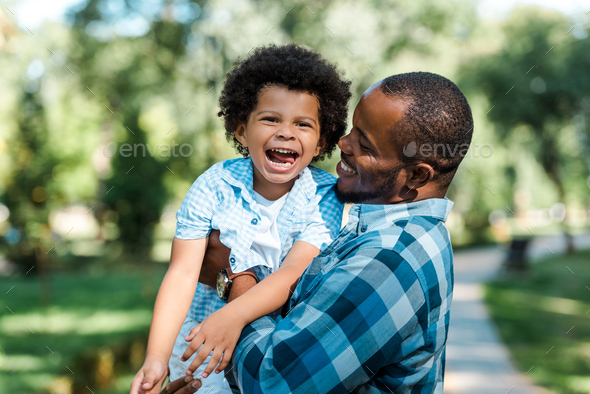 happy african american man holding in arms cheerful son Stock Photo by ...