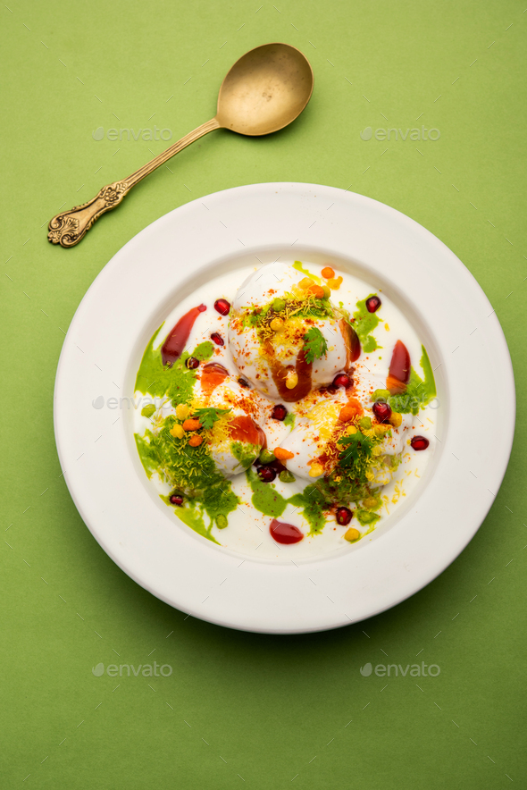 Dahi vada is Indian snack food. Garnished with coriander, boondi