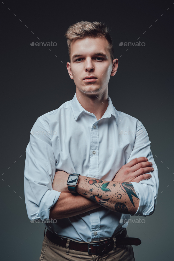 Caucasian hipster wearing custom clothing with crossed arms