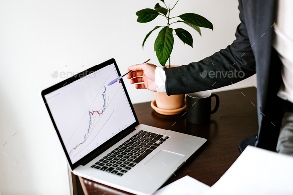 stock trader price trend graph analyzing on laptop and smartphone - Stock Photo - Images