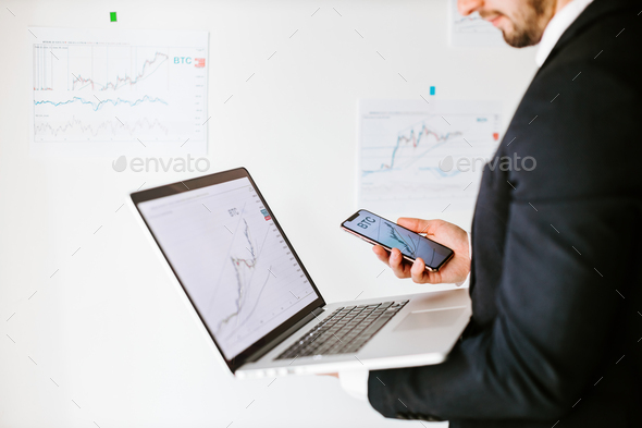stock trader price trend graph analyzing on laptop and smartphone - Stock Photo - Images